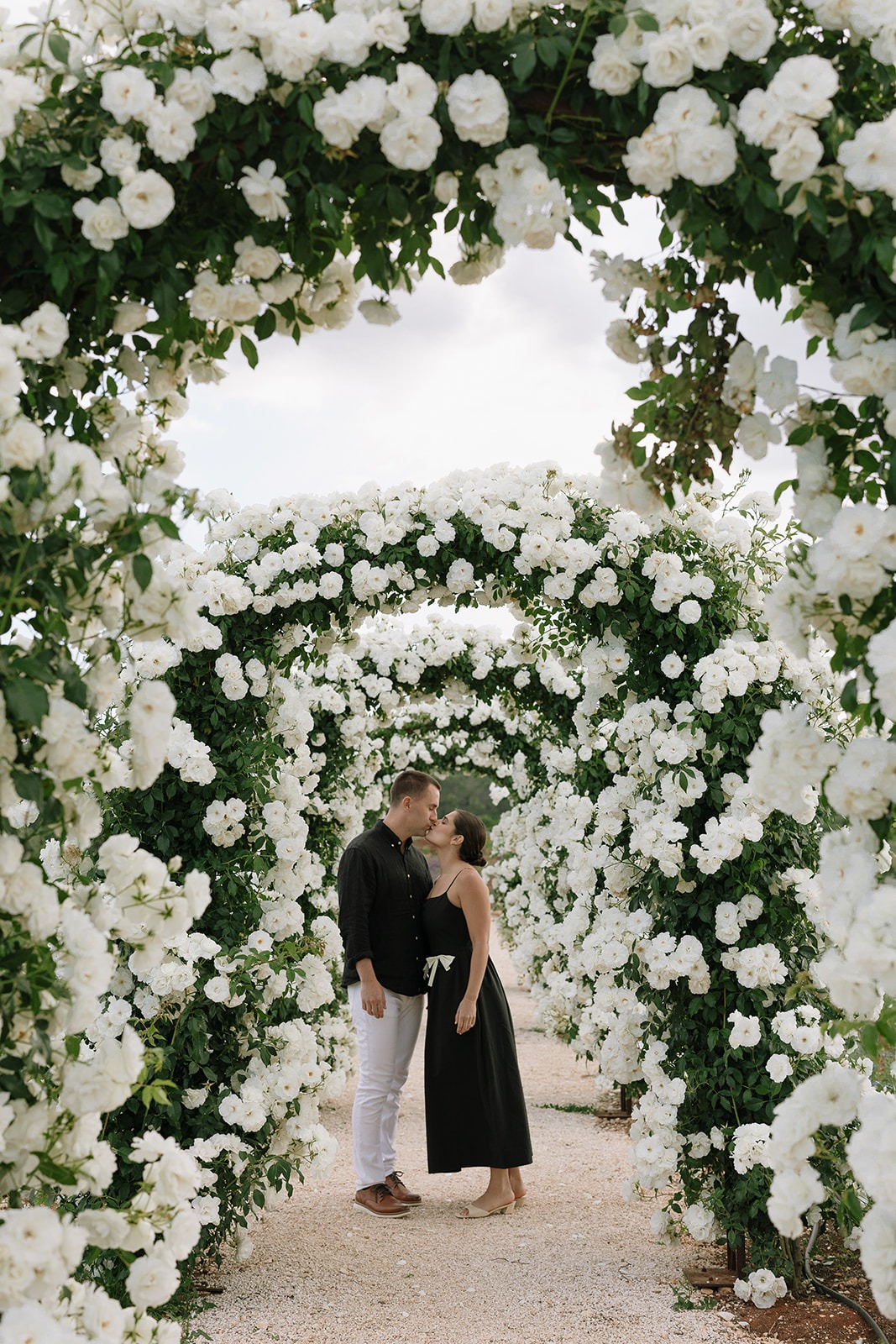 Wedding portraits beneath the rose arches at Giardini Pistola
