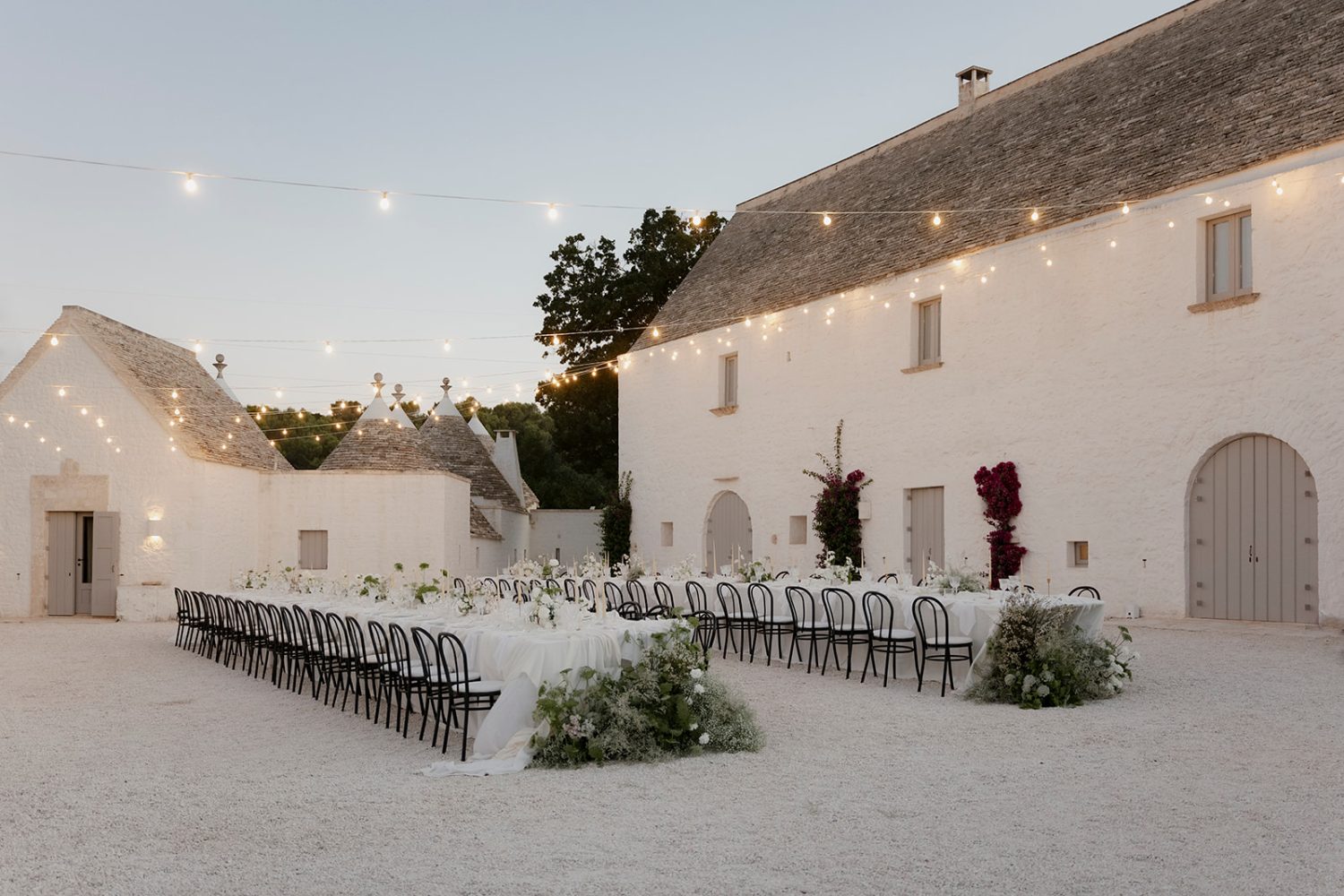 Wedding reception tables in front of Masseria Pistola at dusk