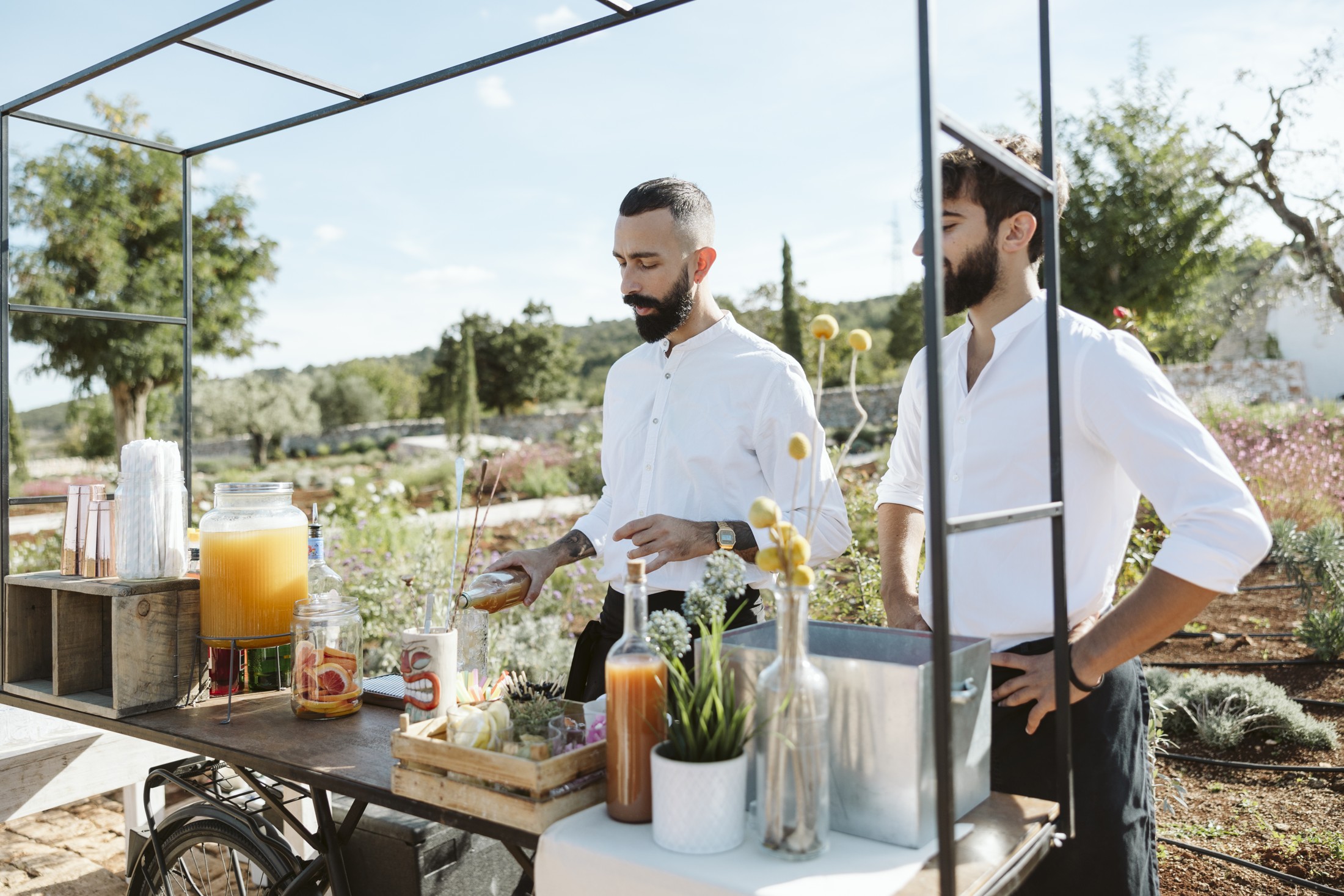 Bartenders preparing cocktails at the garden reception bar