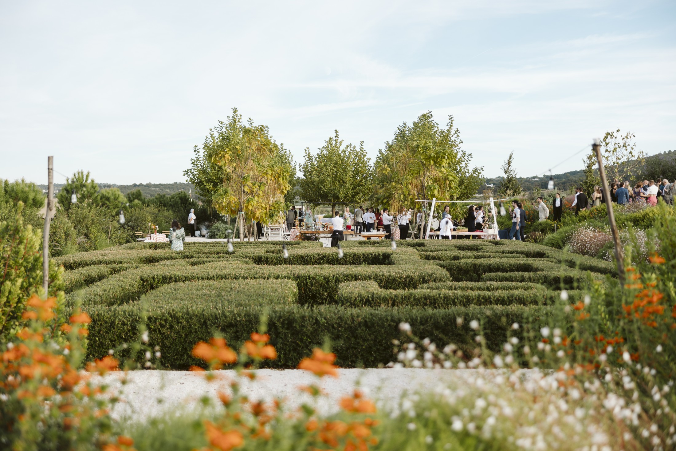 Wedding guests enjoying drinks across the terraced gardens at Giardini Pistola